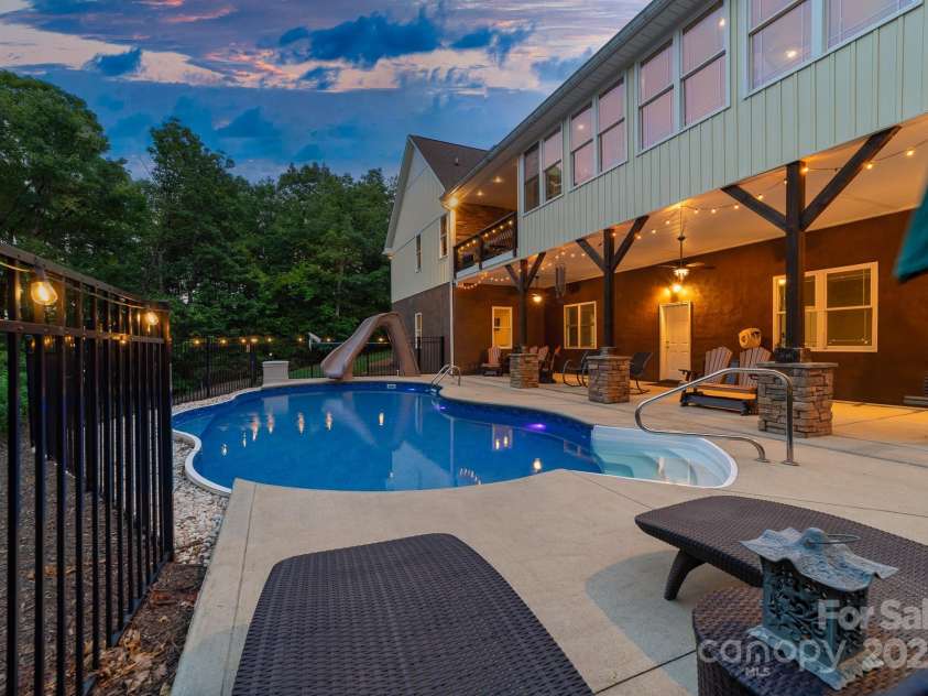 560 Blue Sky Drive, Dallas, NC 28034.  MLS# CAR4262735, YatesRealty ID 31836. Covered Rocking Chair Porch Overlooking the Pool