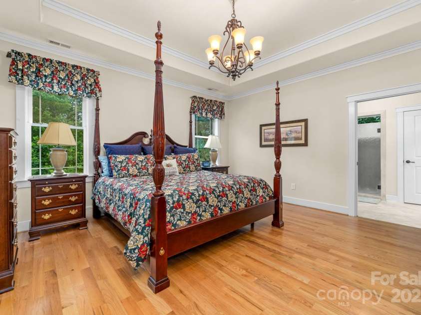 560 Blue Sky Drive, Dallas, NC 28034.  MLS# CAR4262735, YatesRealty ID 31836. Elegant Primary Bedroom EnSuite On The Main Floor.  Featuring Private Access to the Outdoor Balcony Retreat and Trey Celing.