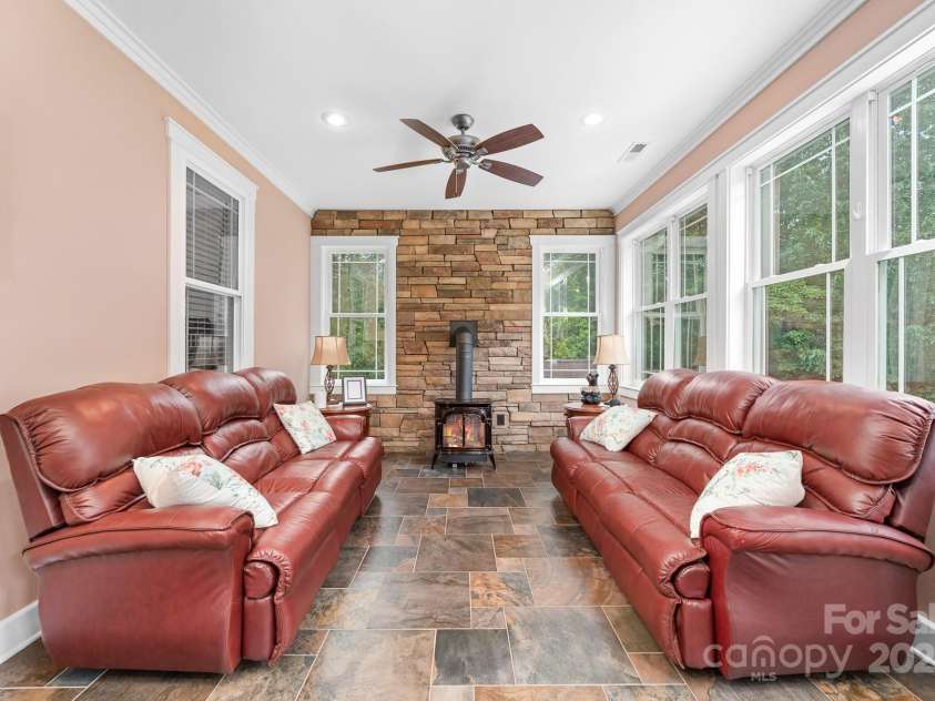 560 Blue Sky Drive, Dallas, NC 28034.  MLS# CAR4262735, YatesRealty ID 31836. Gas Fireplace In The Sun Room For A Cozy Fall & Winter