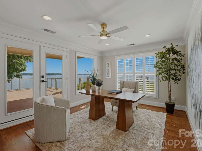 217 Westpaces Road, Mooresville, NC 28117.  MLS# CAR4391335, YatesRealty ID 31846. Dedicated workspace with lake views and direct access to the upper-levelbalcony, creating an inspiring setting for work or relaxation.
