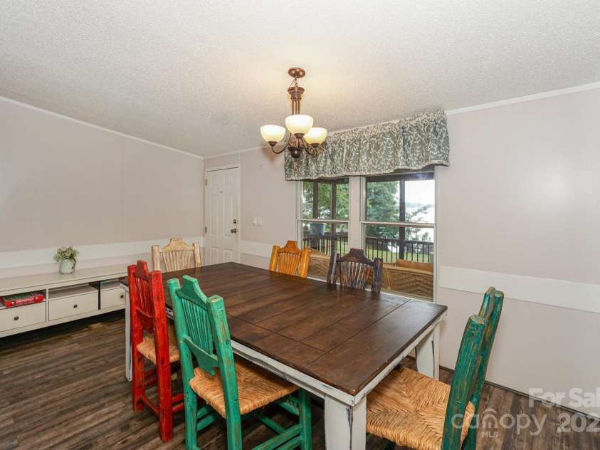 136 Buttercup Drive, Mooresville, NC 28117.  MLS# CAR4284193, YatesRealty ID 31853. Enter the home with newer lvp flooring and enjoy entertaining from the large dining room table off the kitchen.