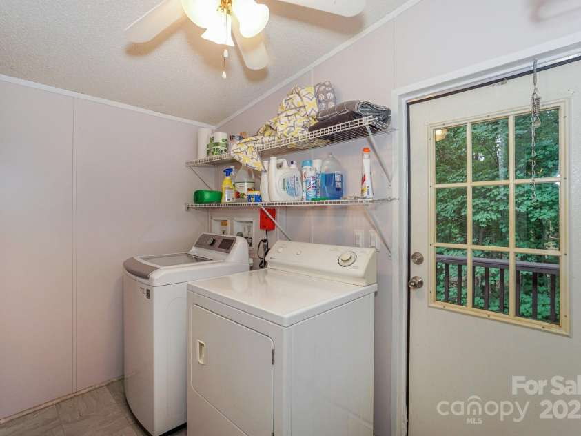 136 Buttercup Drive, Mooresville, NC 28117.  MLS# CAR4284193, YatesRealty ID 31853. Large Laundry Room off kitchen with access door to side deck and backyard.