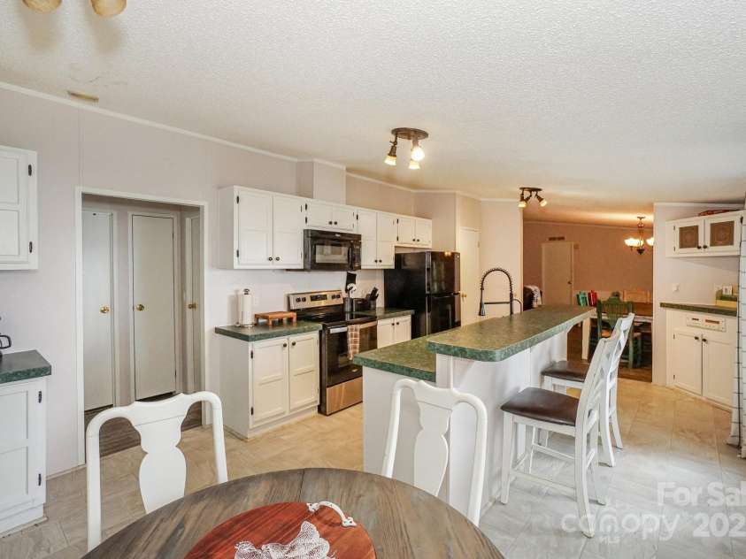 136 Buttercup Drive, Mooresville, NC 28117.  MLS# CAR4284193, YatesRealty ID 31853. Notice the abundance of cabinetry and room to be around guests.