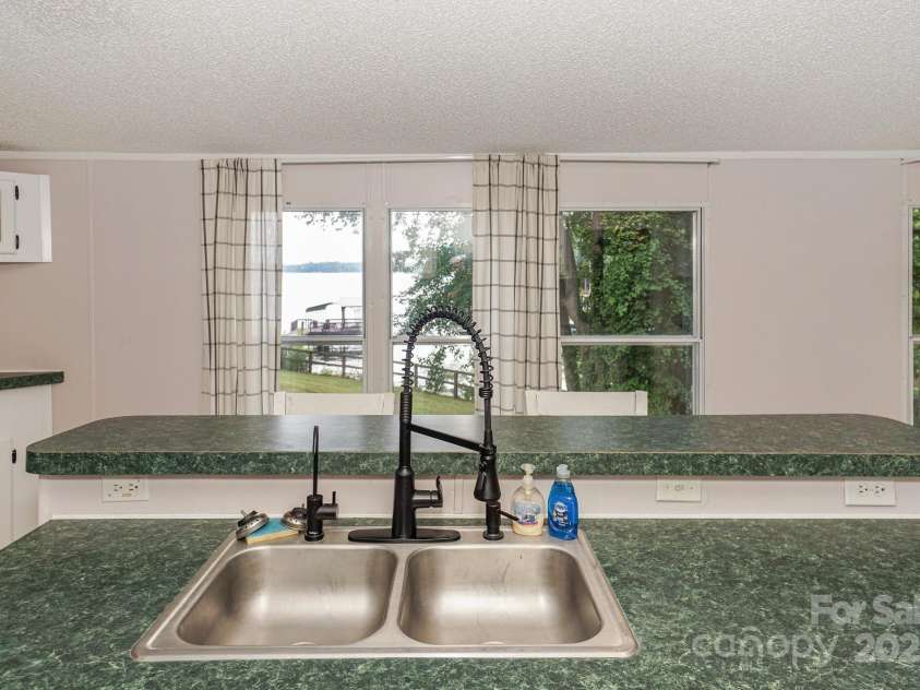 136 Buttercup Drive, Mooresville, NC 28117.  MLS# CAR4284193, YatesRealty ID 31853. What a lovely view while preparing meals and room to entertain guests.