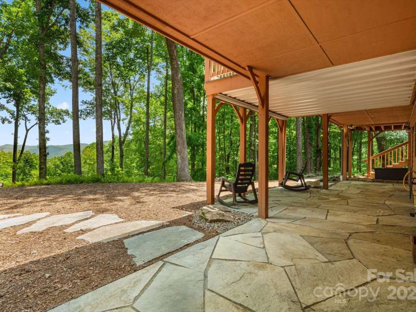 492 Henry Mountain Road, Brevard, NC 28712.  MLS# CAR4278583, YatesRealty ID 31855. Basement level flagstone patio.
