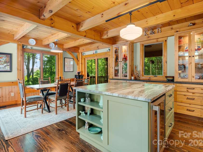 492 Henry Mountain Road, Brevard, NC 28712.  MLS# CAR4278583, YatesRealty ID 31855. Custom cabinets and kitchen island.  Views to the rear of the house.