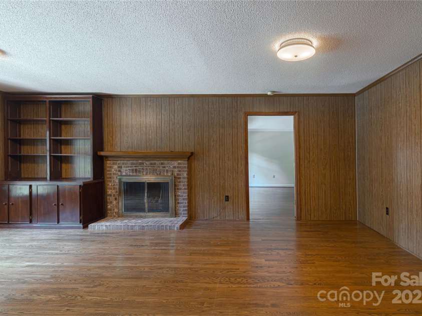 2011 Barden Road, Charlotte, NC 28226.  MLS# CAR4278483, YatesRealty ID 31858. Den off of foyer with view to primary suite.