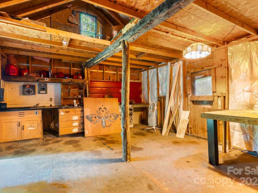 28 Myrtle Road, Swannanoa, NC 28778.  MLS# CAR4289376, YatesRealty ID 31872. Inside of the shed/workshop with storage in loft