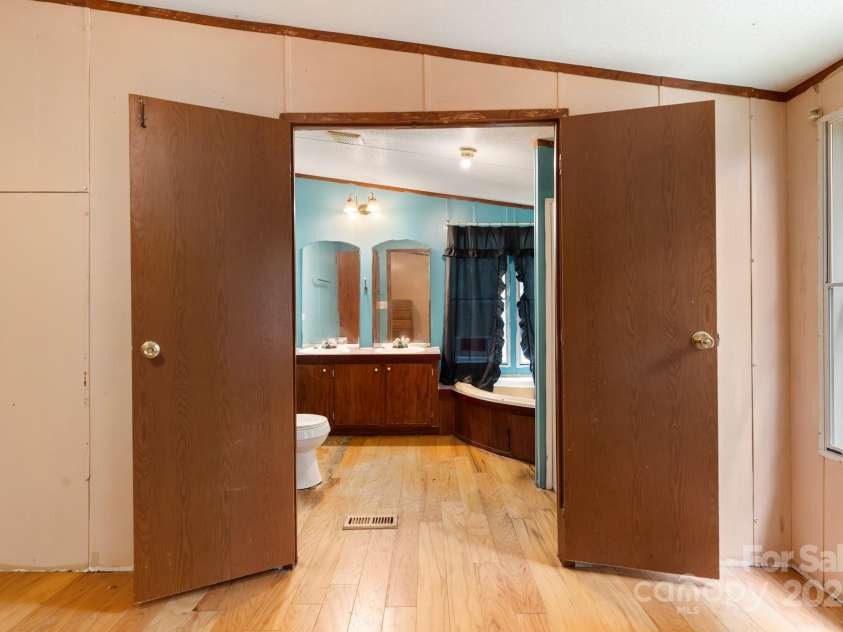 28 Myrtle Road, Swannanoa, NC 28778.  MLS# CAR4289376, YatesRealty ID 31872. Primary bedroom leading to Primary bath