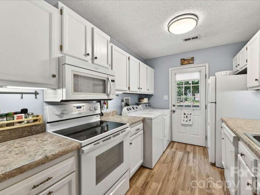 7306 Carrbridge Lane, Charlotte, NC 28226.  MLS# CAR4390862, YatesRealty ID 31888. Gally kitchen has all you need close at hand!