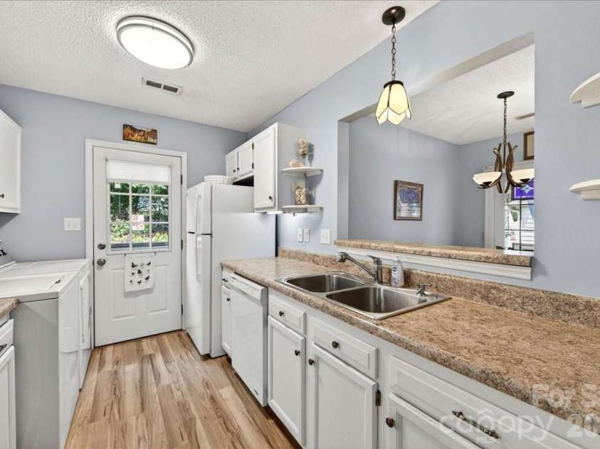 7306 Carrbridge Lane, Charlotte, NC 28226.  MLS# CAR4390862, YatesRealty ID 31888. Kitchen door opens into the back yard for easy access!