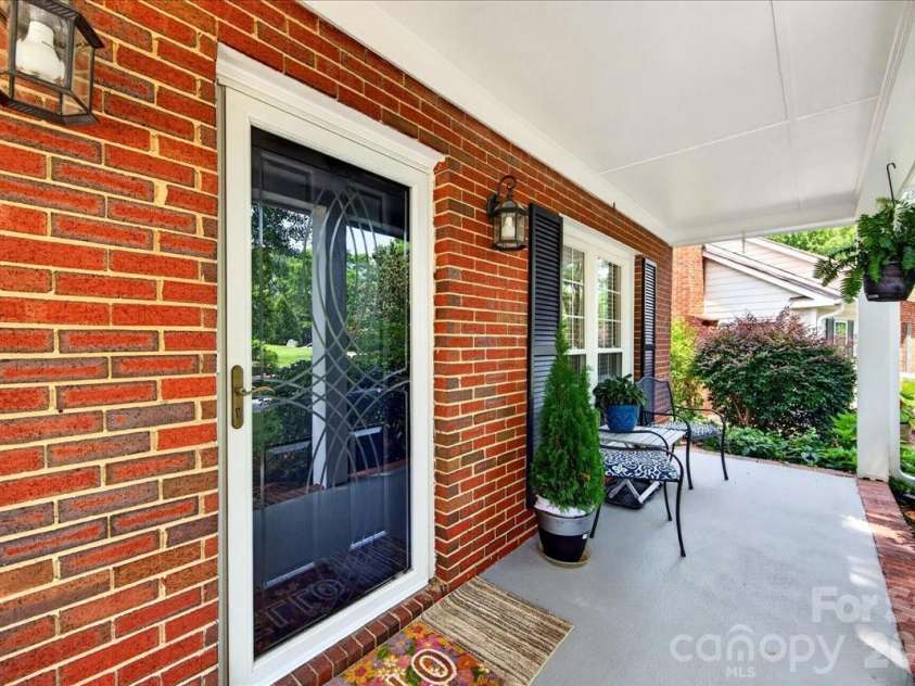 7306 Carrbridge Lane, Charlotte, NC 28226.  MLS# CAR4390862, YatesRealty ID 31888. Partial brick home with an inviting front door and storm door!