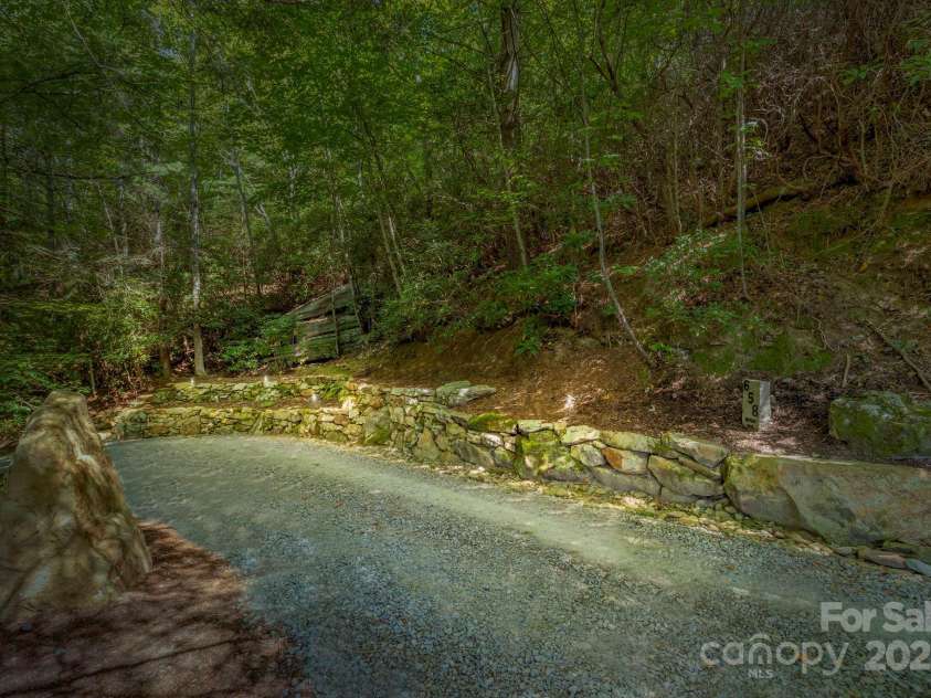 658 Johnson Road, Brevard, NC 28712.  MLS# CAR4300237, YatesRealty ID 319. Exterior lighting showcasing the extensive landscaping