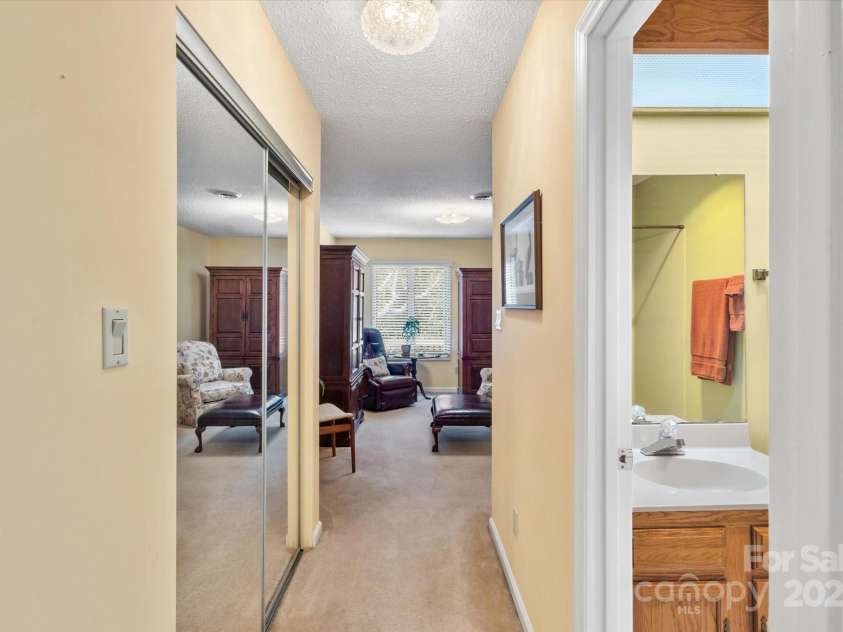 123 Deerlake Drive, Asheville, NC 28803.  MLS# CAR4235089, YatesRealty ID 3190. Bedroom #1 on Main Level w/ view of the Bathroom & 1st Closet