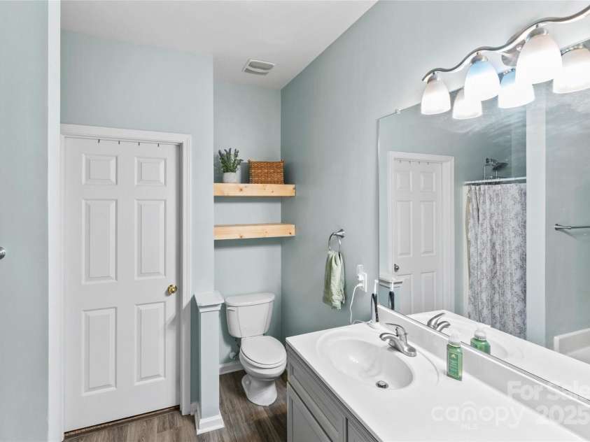 630 Bayou Circle, Clover, SC 29710.  MLS# CAR4284950, YatesRealty ID 31900. The refreshed Primary bath showcases a double vanity, new lighting, upgraded hardware, and toilet blending style and functionality.
