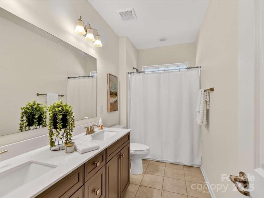 244 Bouchard Drive, Waxhaw, NC 28173.  MLS# CAR4312456, YatesRealty ID 3191. Full bathroom on the second floor features a double vanity with bath / shower combo