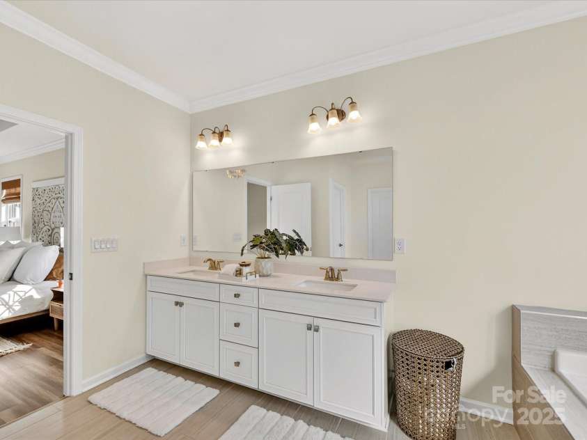 244 Bouchard Drive, Waxhaw, NC 28173.  MLS# CAR4312456, YatesRealty ID 3191. Primary bath features dual vanity sinks, soaking tub and shower.  Walk in closet attached for convience 