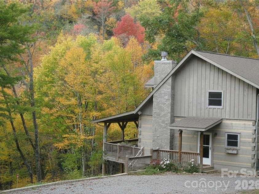 311 Copper Spur Drive, Maggie Valley, NC 28751.  MLS# CAR4387537, YatesRealty ID 31927. Image modified with Canva to remove car and clean up driveway