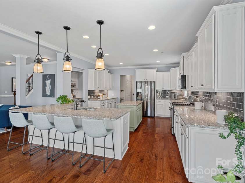 12214 Bonny Oaks Drive, Cornelius, NC 28031.  MLS# CAR4264474, YatesRealty ID 31958. Kitchen boasts stainless steel appliances, quartz counters and tons of prep space!