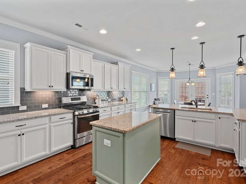12214 Bonny Oaks Drive, Cornelius, NC 28031.  MLS# CAR4264474, YatesRealty ID 31958. Kitchen boasts stainless steel appliances, quartz counters and tons of prep space!