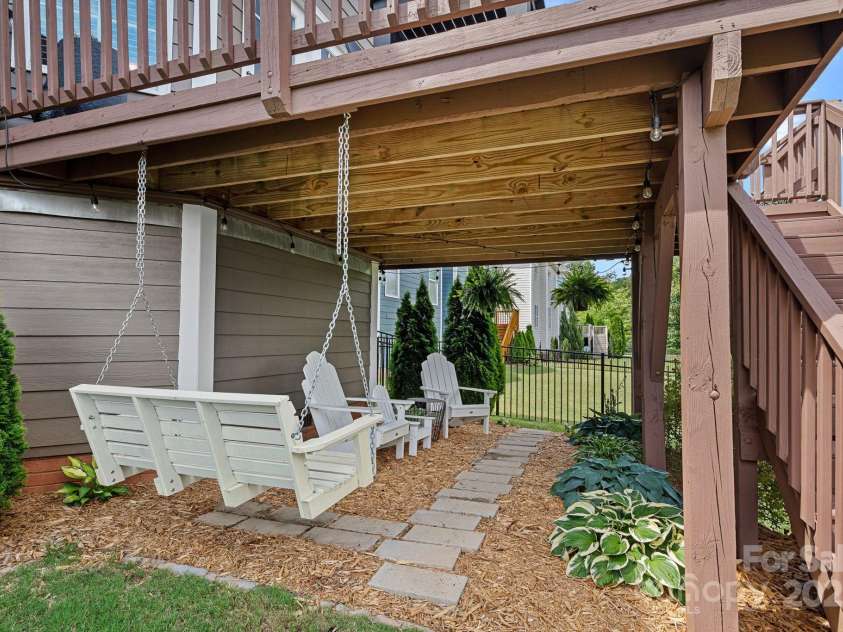 12214 Bonny Oaks Drive, Cornelius, NC 28031.  MLS# CAR4264474, YatesRealty ID 31958. Nice relaxing sitting area under the deck in the backyard!