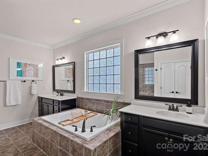 12214 Bonny Oaks Drive, Cornelius, NC 28031.  MLS# CAR4264474, YatesRealty ID 31958. Primary bath has dual vanities and separate tub and large shower!