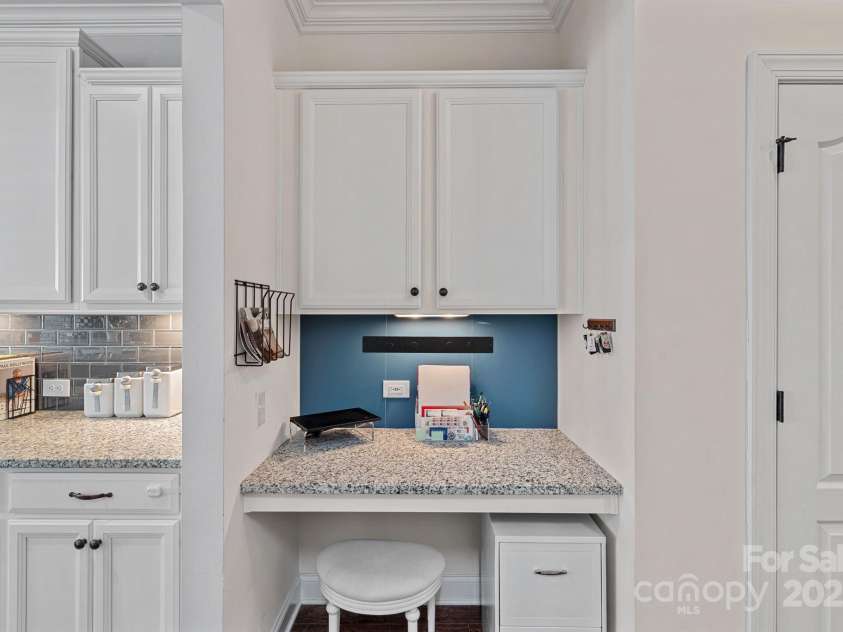 12214 Bonny Oaks Drive, Cornelius, NC 28031.  MLS# CAR4264474, YatesRealty ID 31958. Work station inside double garage door right before the kitchen!