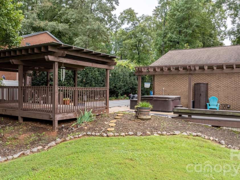 3110 Ninth Tee Drive, Newton, NC 28658.  MLS# CAR4427024, YatesRealty ID 31959. Covered deck, hot tub and pool area oasis