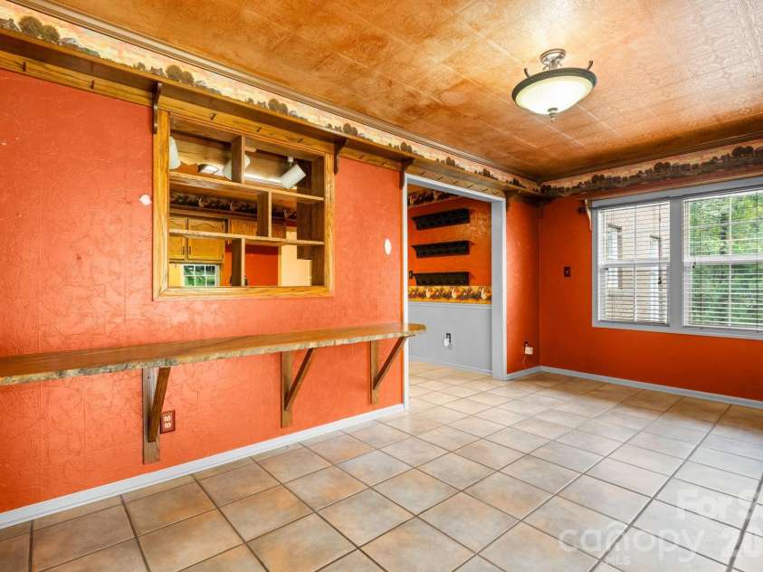 3110 Ninth Tee Drive, Newton, NC 28658.  MLS# CAR4427024, YatesRealty ID 31959. Den area with opening to kitchen