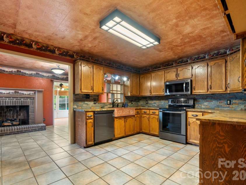 3110 Ninth Tee Drive, Newton, NC 28658.  MLS# CAR4427024, YatesRealty ID 31959. Kitchen view to den that leads into sunroom and mudroom/laundry room