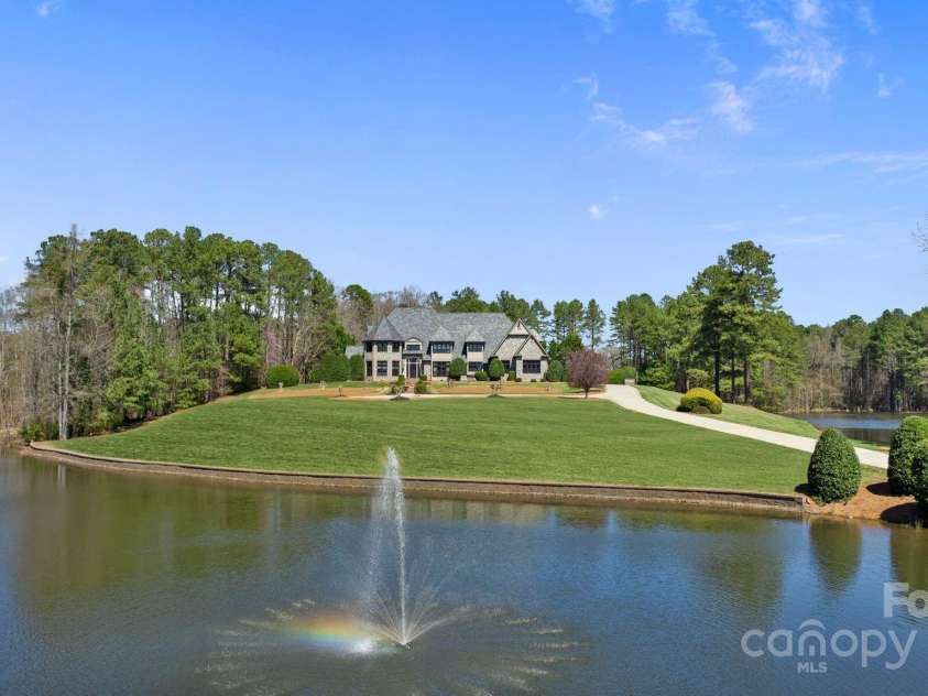 525 Lake Lynn Road, Concord, NC 28025.  MLS# CAR4239397, YatesRealty ID 3196. Driveway view of ponds and house daytime