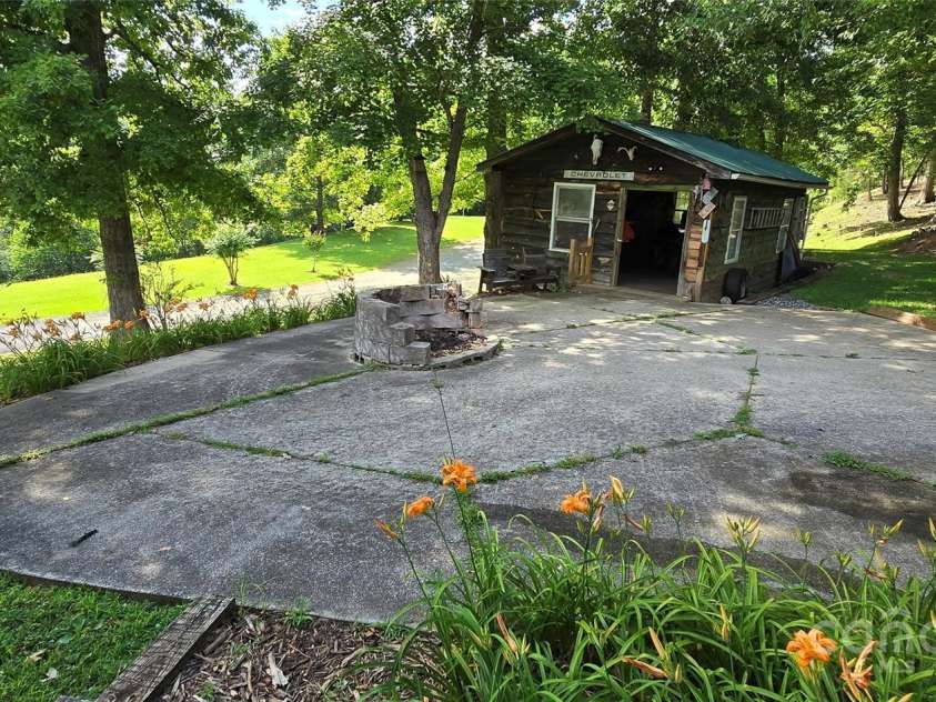 414 Pine Cove Road, Old Fort, NC 28762.  MLS# CAR4276158, YatesRealty ID 31977. Backyard with shop