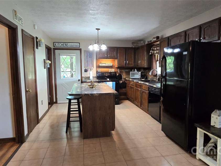 414 Pine Cove Road, Old Fort, NC 28762.  MLS# CAR4276158, YatesRealty ID 31977. Kitchen to front porch