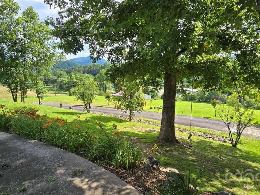 414 Pine Cove Road, Old Fort, NC 28762.  MLS# CAR4276158, YatesRealty ID 31977. Side yard