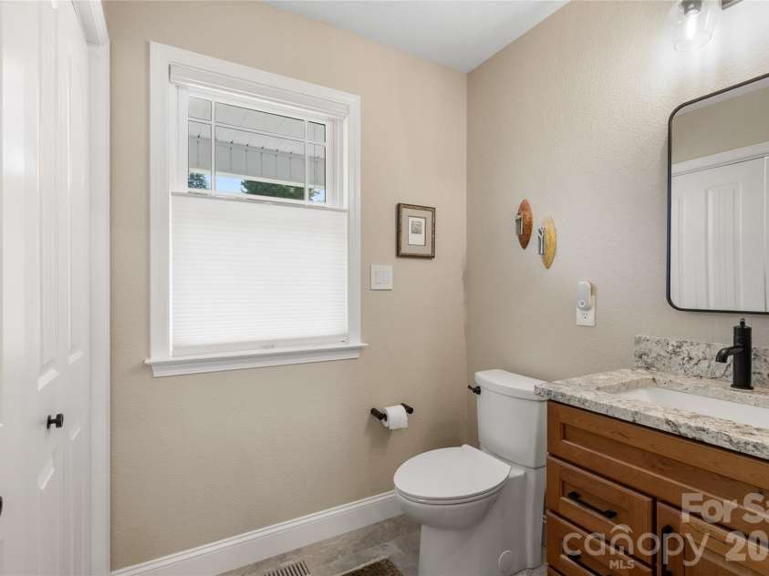 34 Justice Drive, Leicester, NC 28748.  MLS# CAR4394117, YatesRealty ID 31989. Main level half bath with granite counters and cherry cabinets