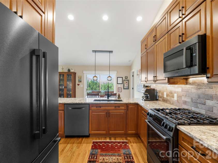 34 Justice Drive, Leicester, NC 28748.  MLS# CAR4394117, YatesRealty ID 31989. Seamless granite countertops with custom backsplash