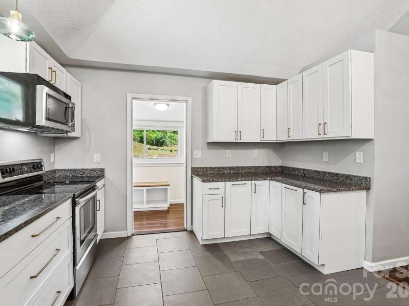 3 View Street, Asheville, NC 28803.  MLS# CAR4383178, YatesRealty ID 31991. Kitchen cabinets and entryway to flex room