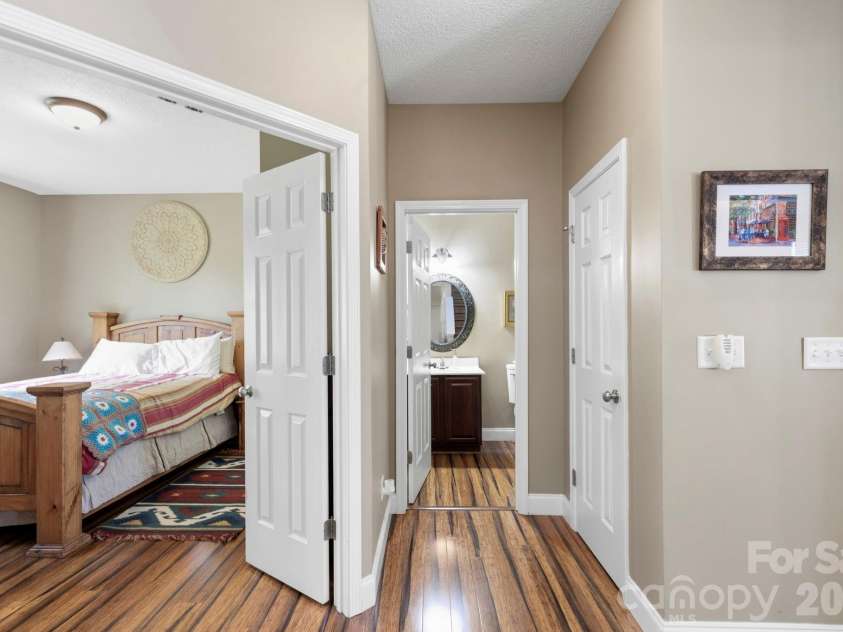 266 Wildbriar Road, Fletcher, NC 28732.  MLS# CAR4394463, YatesRealty ID 32005. Convenient main-level bedroom entry featuring private half-bath access and ample storage nearby.