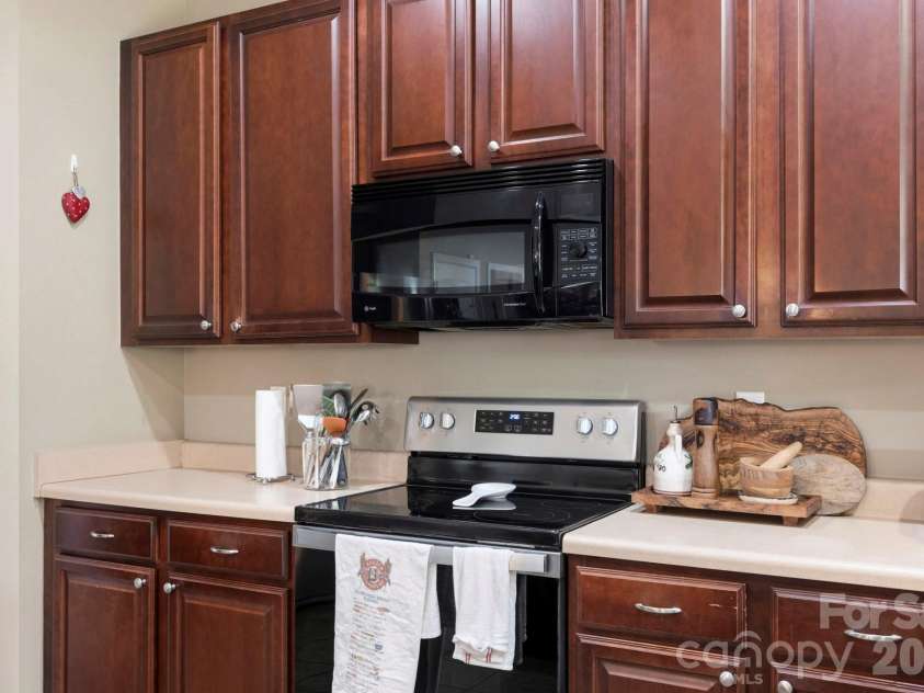 266 Wildbriar Road, Fletcher, NC 28732.  MLS# CAR4394463, YatesRealty ID 32005. Functional kitchen workspace with ample cabinetry, modern appliances, and durable low-maintenance surfaces.