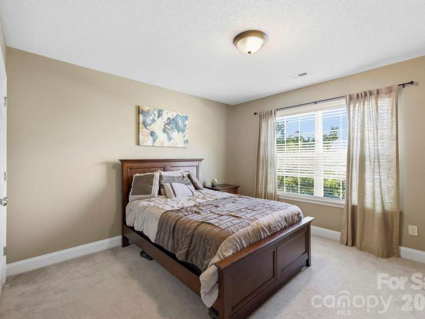 266 Wildbriar Road, Fletcher, NC 28732.  MLS# CAR4394463, YatesRealty ID 32005. Spacious upper-level bedroom with neutral décor, large window, and comfortable layout for everyday living.