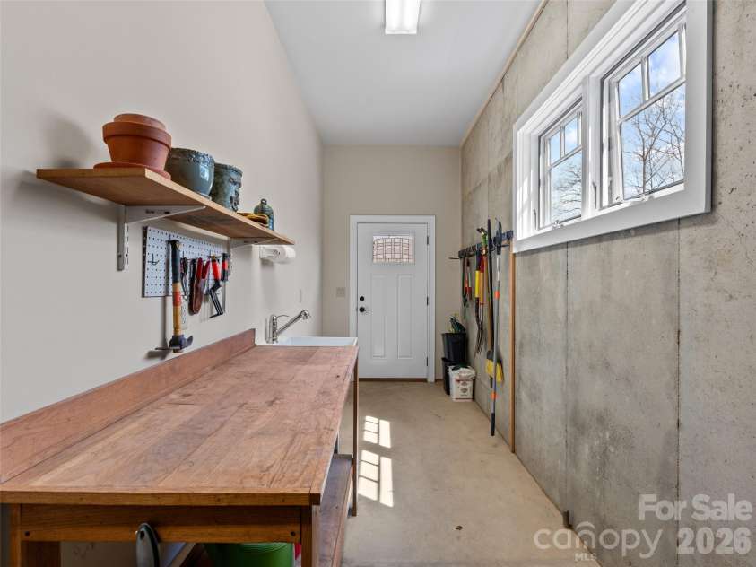 276 Stone Valley Way, Hendersonville, NC 28792.  MLS# CAR4356812, YatesRealty ID 32007. Storage Room/Workshop on Lower Level with Stair access from garage.