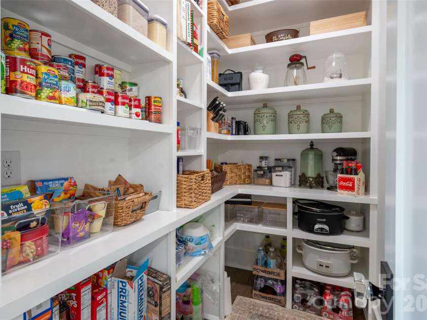 10035 Whispering Falls Avenue, Charlotte, NC 28227.  MLS# CAR4393646, YatesRealty ID 32047. A custom built-in pantry provides seamless, convenient storage with thoughtful design and refined functionality.