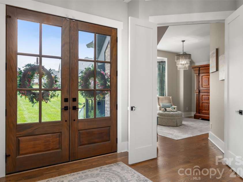 10035 Whispering Falls Avenue, Charlotte, NC 28227.  MLS# CAR4393646, YatesRealty ID 32047. A grand foyer welcomes you with rich hardwood flooring, setting the tone for the home's refined elegance and impeccable craftsmanship.