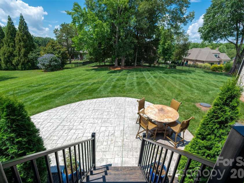 10035 Whispering Falls Avenue, Charlotte, NC 28227.  MLS# CAR4393646, YatesRealty ID 32047. Level backyard offering endless possibilities for recreation, gatherings, and future outdoor enhancements.