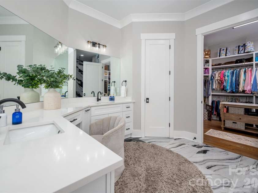 10035 Whispering Falls Avenue, Charlotte, NC 28227.  MLS# CAR4393646, YatesRealty ID 32047. The primary bathroom features a double vanity with an oversized layout, complemented by elegant marble flooring for a refined spa-like feel.