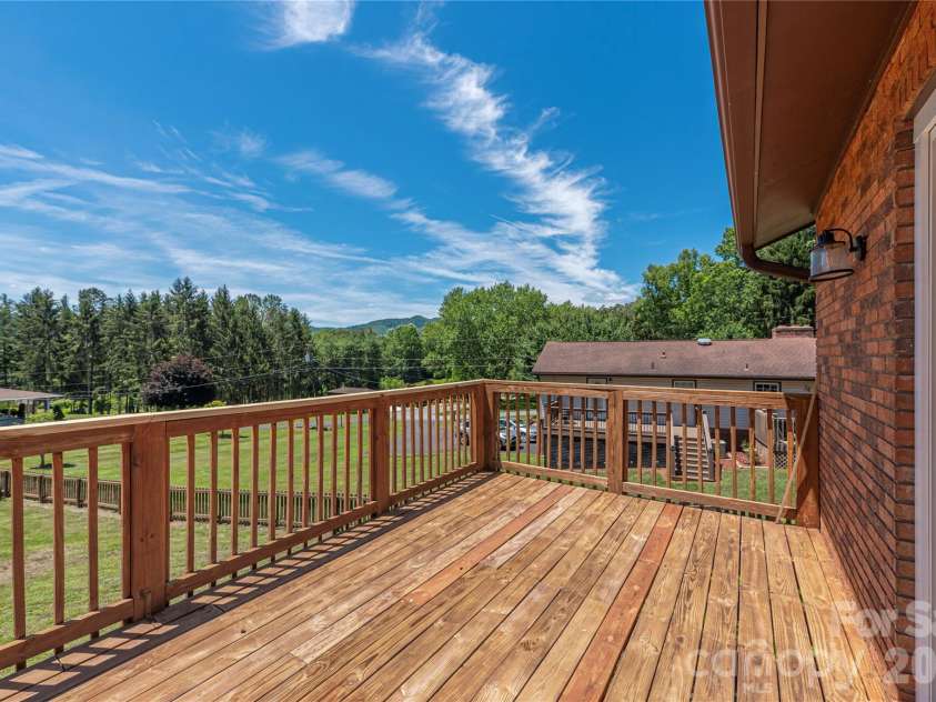 99 Young Drive, Candler, NC 28715.  MLS# CAR4388636, YatesRealty ID 32054. Huge back deck off the living room
