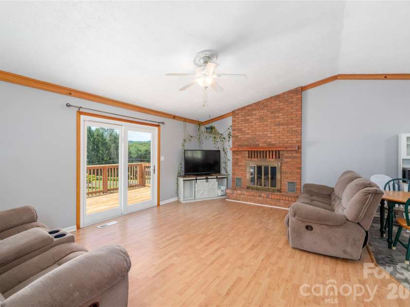 99 Young Drive, Candler, NC 28715.  MLS# CAR4388636, YatesRealty ID 32054. Living room with access to large back deck