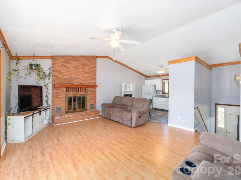 99 Young Drive, Candler, NC 28715.  MLS# CAR4388636, YatesRealty ID 32054. Living room with brick fireplace