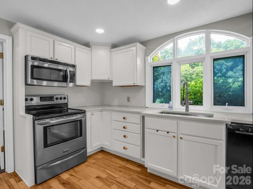 35 Chastain Hill Road, Mills River, NC 28759.  MLS# CAR4388520, YatesRealty ID 32063. Kitchen facing oven, Laundry Room to the left