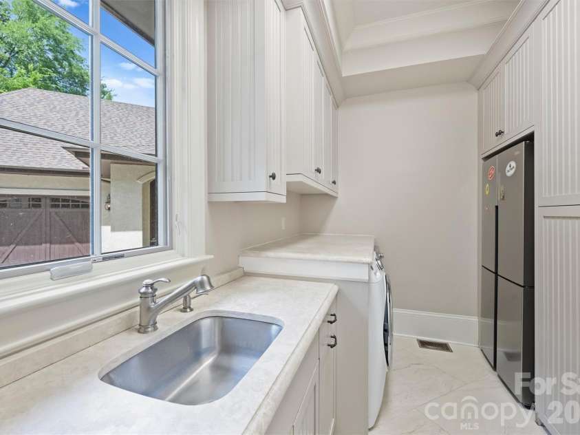 4901 Carmel Park Drive, Charlotte, NC 28226.  MLS# CAR4379174, YatesRealty ID 32065. Laundry room, extra fridge/freezer/ storage